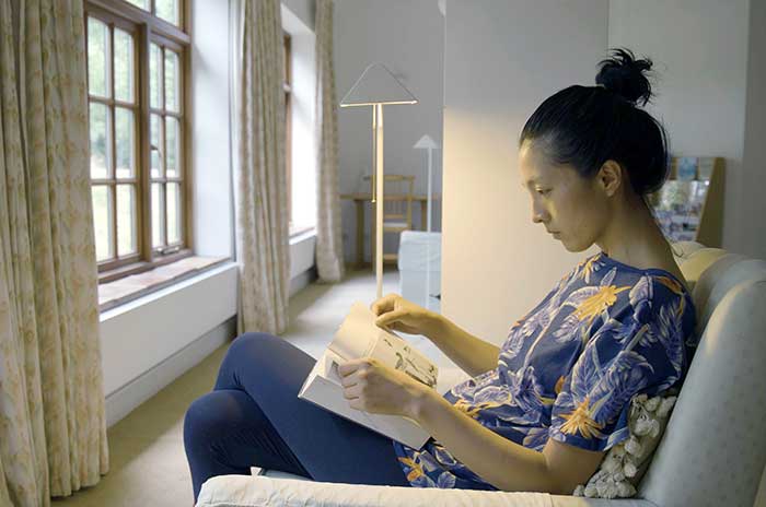 A young woman reading a book in the Krishnamurti Centre library